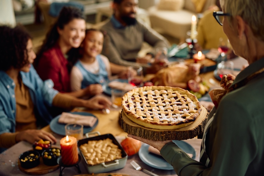 family eating thanksgiving dinner, how holidays affects your smile