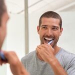 man brushing his teeth a great part of a healthy dental routine austin