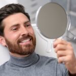Man smiling after cosmetic dental treatment